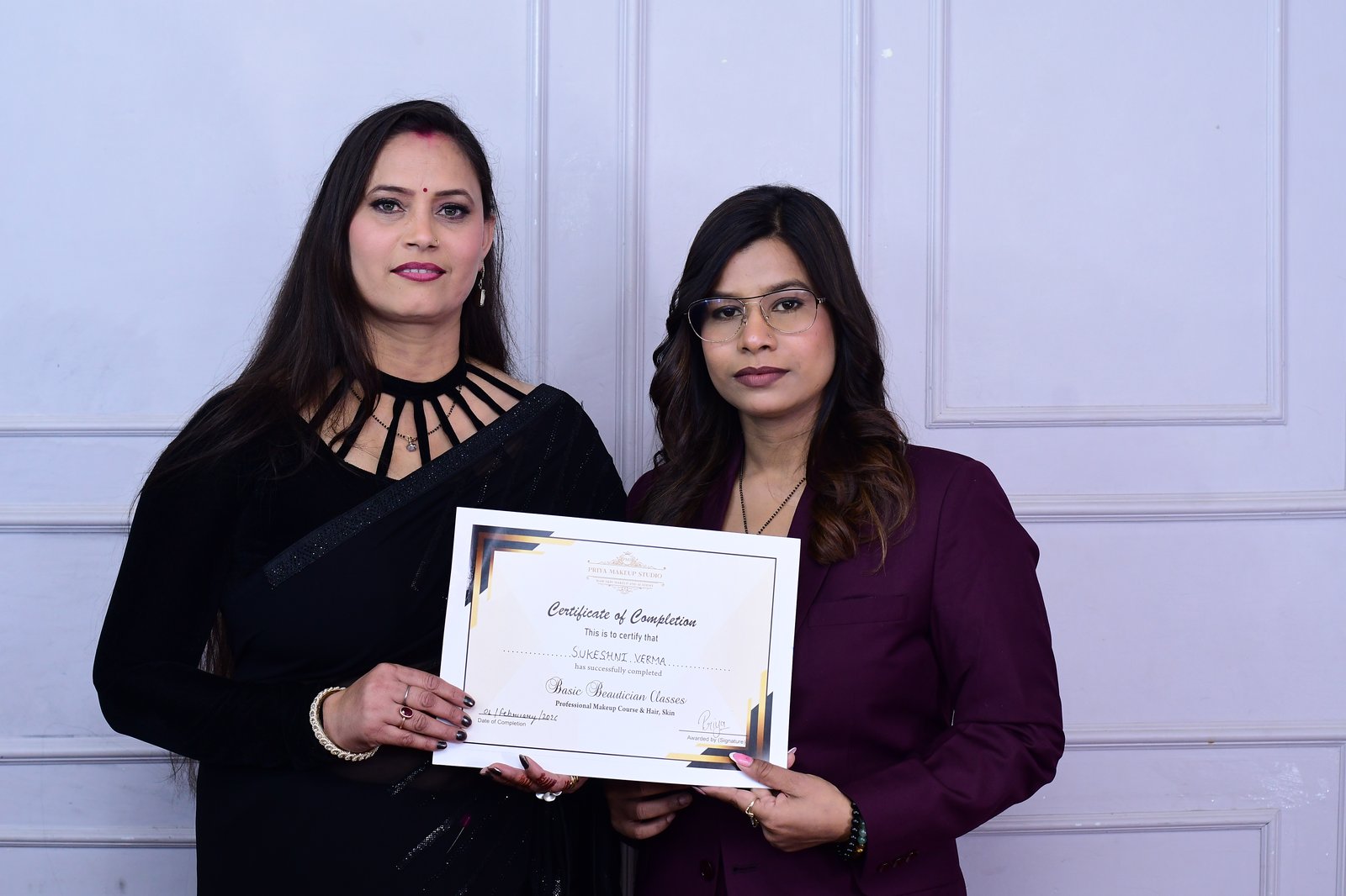 Priya Makeup Academy graduate holding Certificate of Completion