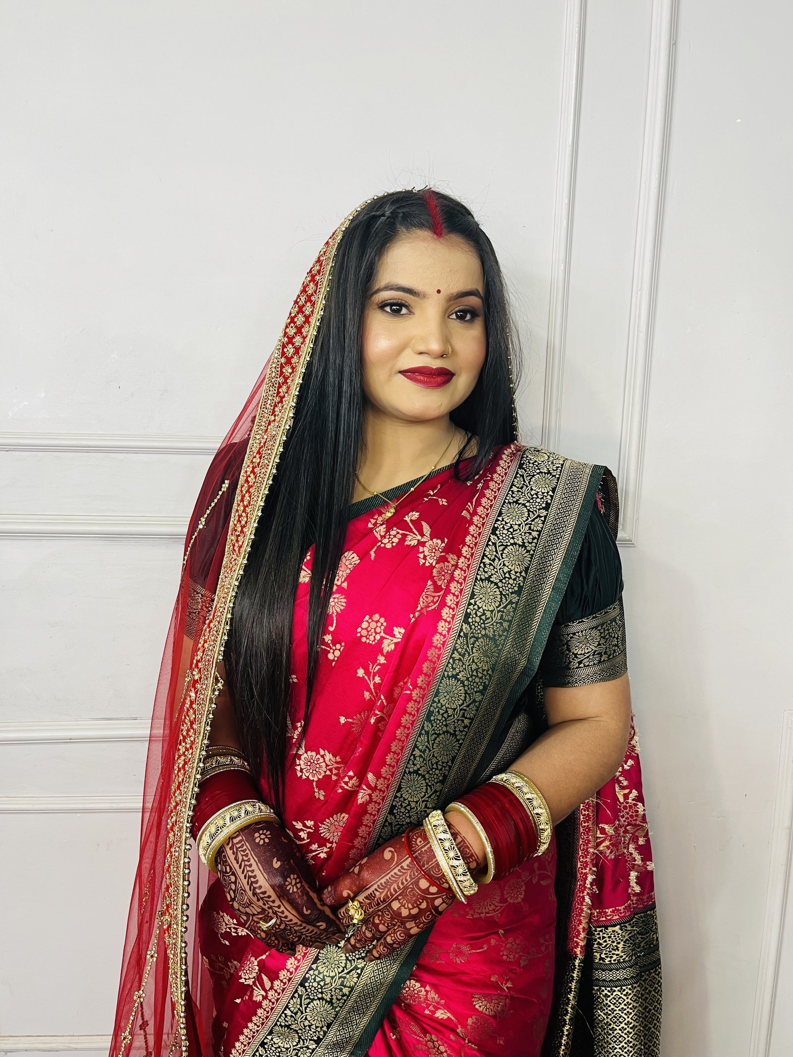 Indian bride in red and gold bridal makeup by Priya Makeup Studio