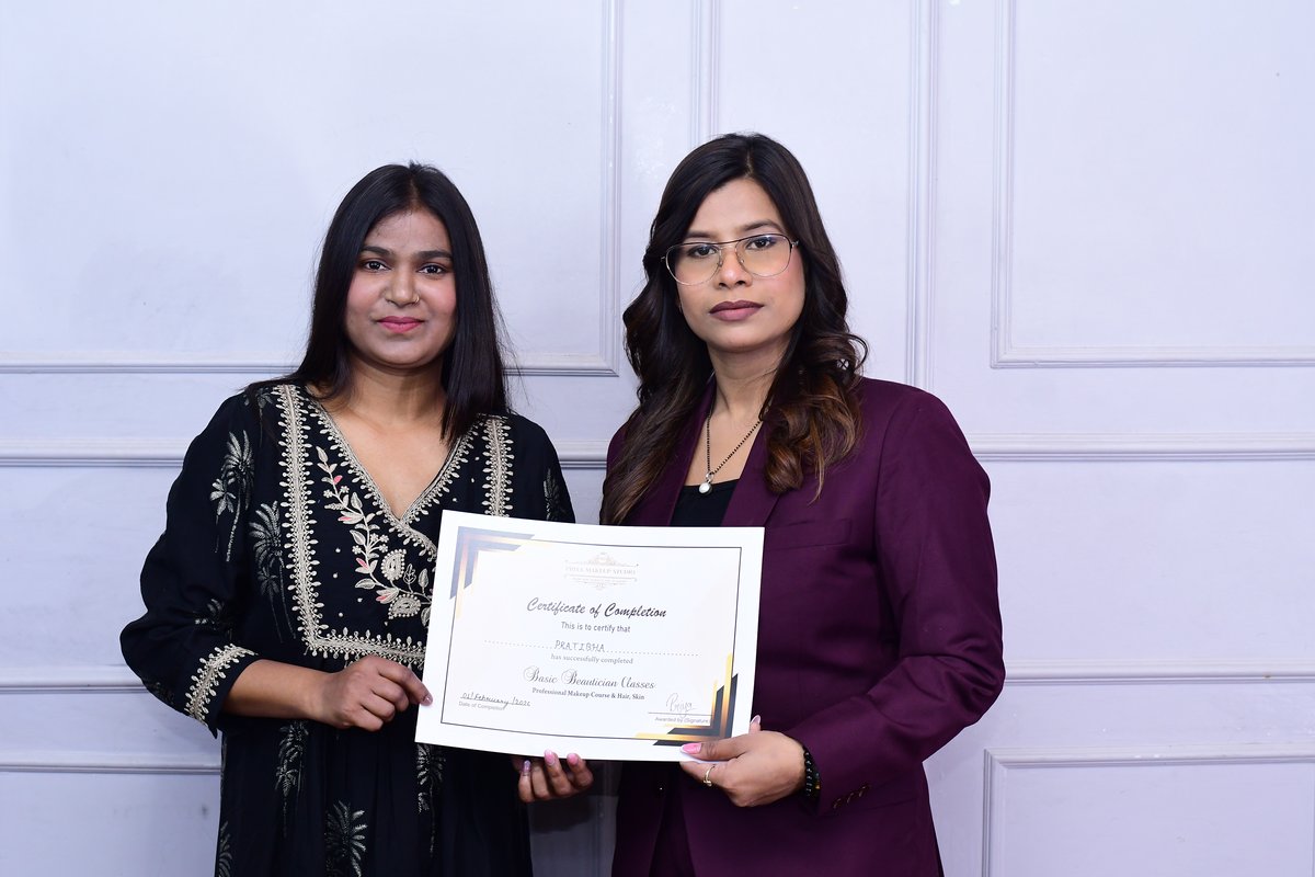 Student holding beautician course certificate